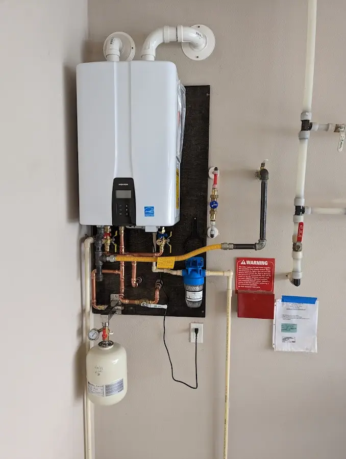 Professional plumber installing copper piping in a Benton home